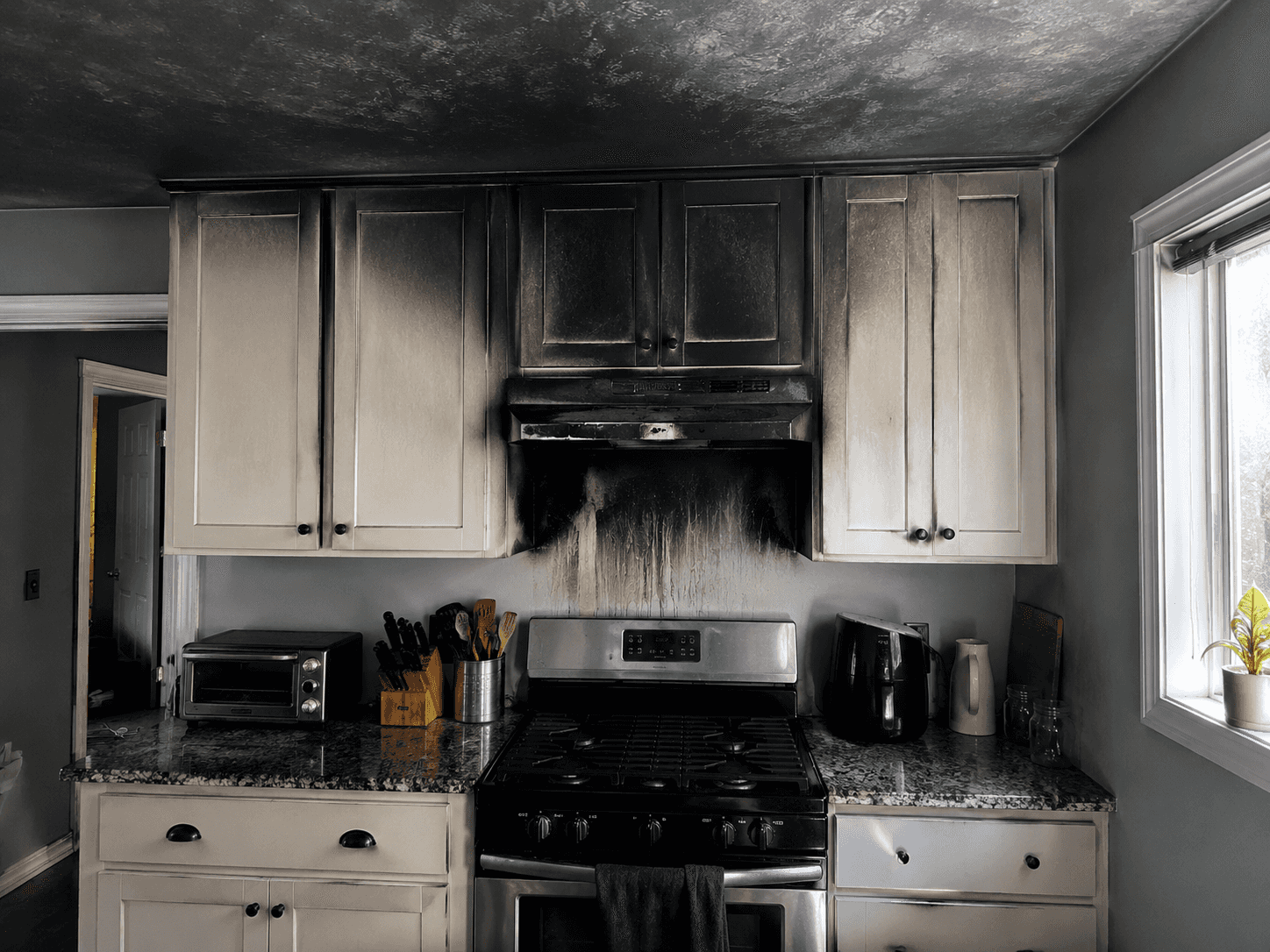 A kitchen damaged by smoke.