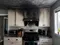 A kitchen damaged by smoke.