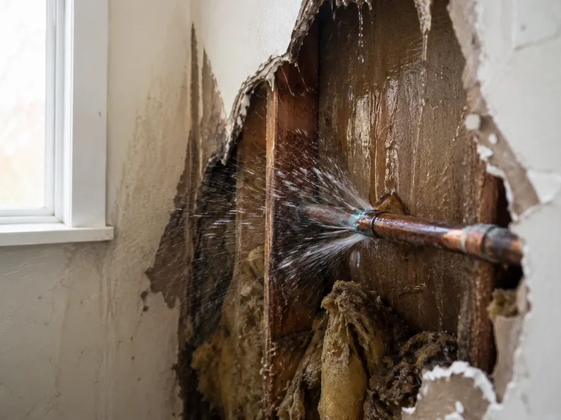 A burst pipe in the wall.